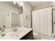 Bright bathroom featuring a white vanity, modern fixtures, and a shower with a white curtain at 164 Inwood Walk, Woodstock, GA 30188
