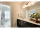 Bathroom featuring double vanity with dark cabinets, white countertop, and framed mirror at 164 Inwood Walk, Woodstock, GA 30188