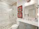 Modern bathroom featuring a glass-enclosed shower, stylish vanity, and decorative pebble flooring at 164 Inwood Walk, Woodstock, GA 30188