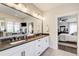 Large bathroom offers double sinks with granite countertops and an adjoining bedroom view at 164 Inwood Walk, Woodstock, GA 30188