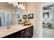 Bathroom featuring double vanity with dark cabinets, white countertop, and a framed mirror at 164 Inwood Walk, Woodstock, GA 30188