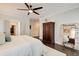 This bedroom features dark hardwood floors, a ceiling fan and a large decorative mirror at 164 Inwood Walk, Woodstock, GA 30188