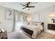 Bedroom features a ceiling fan, 2 windows with curtains and a view to an ensuite bathroom at 164 Inwood Walk, Woodstock, GA 30188
