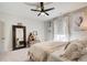 Bright bedroom features a ceiling fan, full-length mirror and decorative wall art at 164 Inwood Walk, Woodstock, GA 30188