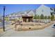 Community entrance featuring the name 'Bluestone Park' along sidewalk, covered area and landscaping at 164 Inwood Walk, Woodstock, GA 30188