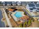 Aerial view of the community pool area, featuring a lounge and shade structure near attractive neighborhood homes at 164 Inwood Walk, Woodstock, GA 30188