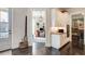 Inviting entryway with hardwood floors leading to a view of the office and kitchen cabinets at 164 Inwood Walk, Woodstock, GA 30188