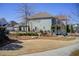 Exterior view of a two-story home with well-manicured landscaping, lawn and sidewalks at 164 Inwood Walk, Woodstock, GA 30188