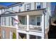 Charming two-story home with a covered porch, American flag, and beautiful exterior at 164 Inwood Walk, Woodstock, GA 30188