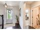 Welcoming foyer with dark wood floors, neutral walls, and a decorative front door at 164 Inwood Walk, Woodstock, GA 30188