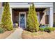 Close-up of the front entrance, showcasing a stylish front door, manicured landscaping, and charming details at 164 Inwood Walk, Woodstock, GA 30188