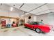 Spacious two car garage with storage and classic red car at 164 Inwood Walk, Woodstock, GA 30188