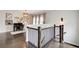 Second floor hallway featuring dark hardwood floors, iron railing, and a desk at 164 Inwood Walk, Woodstock, GA 30188