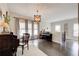 Spacious living room area with piano, large windows, and hardwood flooring at 164 Inwood Walk, Woodstock, GA 30188