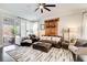 Inviting living area with leather furniture, area rug, neutral walls, and natural light from the open door to patio at 164 Inwood Walk, Woodstock, GA 30188
