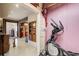 Eclectic living space with exercise equipment, stained beams, and a unique refrigerator feature at 164 Inwood Walk, Woodstock, GA 30188