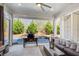 Relaxing sunroom with comfortable seating, an outdoor grill, and a view of the private, landscaped backyard at 164 Inwood Walk, Woodstock, GA 30188