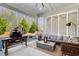 Comfortable sunroom with a ceiling fan, neutral decor, and a view of the landscaped backyard at 164 Inwood Walk, Woodstock, GA 30188