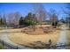 Well-maintained community walking path surrounded by lush landscaping and mature trees on a sunny day at 164 Inwood Walk, Woodstock, GA 30188