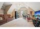 Spacious bonus room with a couch, media center, and exercise bike at 1800 Hunters Moon Dr, Alpharetta, GA 30005