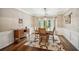Elegant dining room featuring wainscoting, hardwood floors, and a modern chandelier at 1800 Hunters Moon Dr, Alpharetta, GA 30005