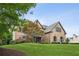 Traditional brick home with lush lawn and mature tree, creating a welcoming entrance at 1800 Hunters Moon Dr, Alpharetta, GA 30005