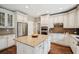 Modern kitchen features a center island, stainless steel appliances, and custom white cabinetry at 1800 Hunters Moon Dr, Alpharetta, GA 30005