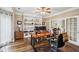 Well-lit home office with custom built-in shelving and a large wooden desk at 1800 Hunters Moon Dr, Alpharetta, GA 30005