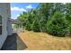 Spacious backyard with lush green trees, patio area, well-maintained lawn and a fence at 193 Treeline Trl, Canton, GA 30115