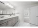 Bathroom featuring double sinks, a framed mirror, and access to the main bedroom at 193 Treeline Trl, Canton, GA 30115