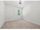 Clean and bright bedroom with neutral carpet, white walls, and a window at 193 Treeline Trl, Canton, GA 30115