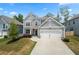 Charming two-story home featuring neutral siding, white trim, a two-car garage, and manicured landscaping at 193 Treeline Trl, Canton, GA 30115