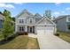Charming two-story home features a landscaped yard, gray siding, and a two-car garage, offering excellent curb appeal at 193 Treeline Trl, Canton, GA 30115