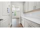 Hallway with white cabinets, drawers, countertops, and white subway tile backsplash at 193 Treeline Trl, Canton, GA 30115