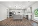 Open kitchen with gray cabinets, stainless steel appliances, a center island, and hardwood floors, perfect for cooking at 193 Treeline Trl, Canton, GA 30115
