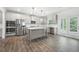 Modern kitchen featuring stainless steel appliances, a large kitchen island, and direct access to the backyard at 193 Treeline Trl, Canton, GA 30115