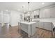 Modern kitchen features a gray island, stainless steel appliances, and stylish pendant lighting, creating a culinary delight at 193 Treeline Trl, Canton, GA 30115
