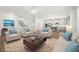 Bright, open living room with hardwood floors, neutral furnishings, and seamless access to the kitchen and staircase at 193 Treeline Trl, Canton, GA 30115