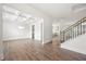 Bright living room showcasing hardwood floors, coffered ceilings, and an open floor plan to a modern kitchen and staircase at 193 Treeline Trl, Canton, GA 30115