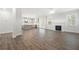 Spacious living room open to the kitchen featuring a fireplace and hardwood floors at 193 Treeline Trl, Canton, GA 30115