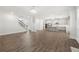 Expansive living room with hardwood floors, offering an open view of the staircase and a well-equipped kitchen at 193 Treeline Trl, Canton, GA 30115