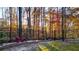 Backyard featuring a black metal fence, retaining wall, and mature trees at 271 Brooks Rackley Rd, Dallas, GA 30157