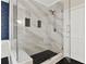Bathroom features modern walk in shower with white marble tile and black tile base at 271 Brooks Rackley Rd, Dallas, GA 30157