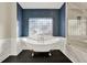 Bathroom featuring freestanding tub, glass blocked window, and marble walk-in shower at 271 Brooks Rackley Rd, Dallas, GA 30157