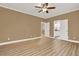 Large bedroom with laminate flooring, crown molding, and multiple doorways at 271 Brooks Rackley Rd, Dallas, GA 30157