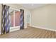 Bright bedroom features a large window with curtains and hardwood flooring at 271 Brooks Rackley Rd, Dallas, GA 30157