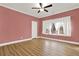 Bedroom featuring wood floors, a window and a ceiling fan at 271 Brooks Rackley Rd, Dallas, GA 30157