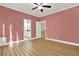 Bedroom includes a ceiling fan, wood floor, and an entrance to the bathroom at 271 Brooks Rackley Rd, Dallas, GA 30157