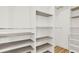 Walk in closet with grey shelves and metal hanging rods at 271 Brooks Rackley Rd, Dallas, GA 30157