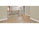 Upper hallway featuring wood floors and a wood and metal decorative banister at 271 Brooks Rackley Rd, Dallas, GA 30157